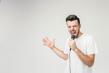 Nice picture of an emotional guy singing in microphone. His trying to do his best and reaches the...