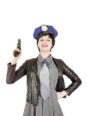 Woman teenager holding a gun in black and white dress and police cap, isolated on white