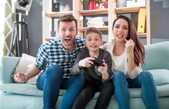 Excited family playing video game at home