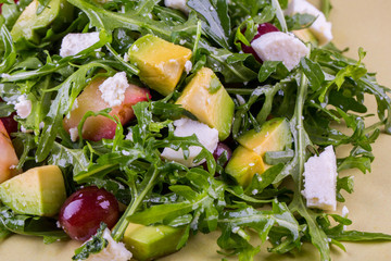 Mango, grapes, cheese of a fetaks with arugula, salad fruit with olive oil