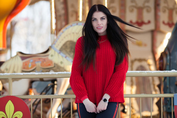 Cheerful beautiful young woman in red sweater