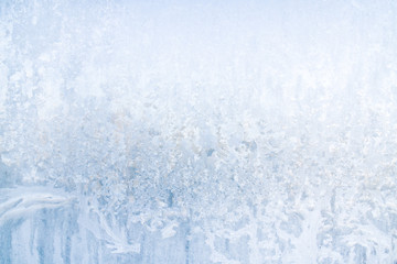 Winter frosty patterns on the frozen ice window