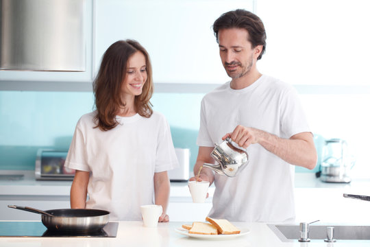 Couple cooking breakfast