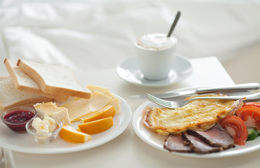 Breakfast in bed in hotel room. Accommodation.