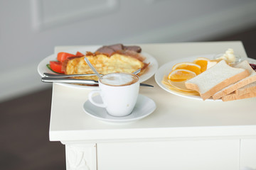 Breakfast in bed in hotel room. Accommodation.