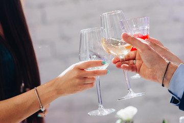 Festive people clinking glasses