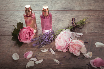 Fototapeta na wymiar Pink English rose, lavender, organic salt and oil, spa wooden background. Rustic style.