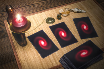 Tarot cards on fortune teller desk table in the candle light. Future reading concept.