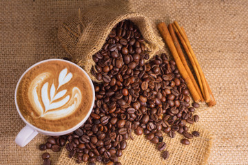 white coffee cup and roasted coffee beans around