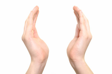 Female hands raised up in a gesture of holding something or praying on a white background in...