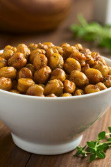 Chickpeas roasted with thyme, oregano, salt and pepper, photographed with natural light (Selective Focus, Focus in the middle of the image)