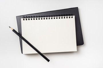 Business concept - Top view collection of two notebook ( kraft spiral and hardcover ) and black pencil isolated on background for mockup