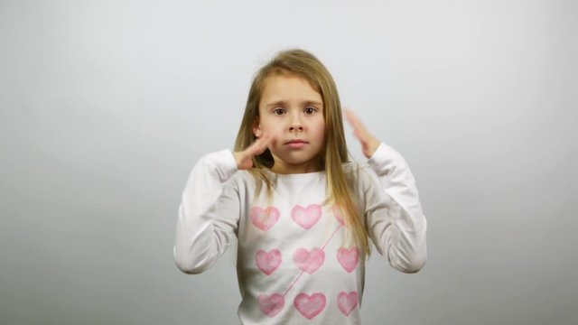 Nervous child trying to calm down. A little girl trying keeping calm in a stressful situation.
