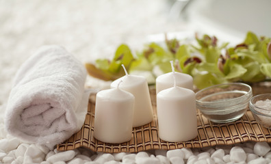 Fototapeta na wymiar Spa still life with aromatic candles, orchid flower and towel.