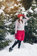 Woman having fun in winter forest