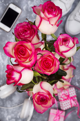 composed of the roses and mobile phone on the back of a blurry background