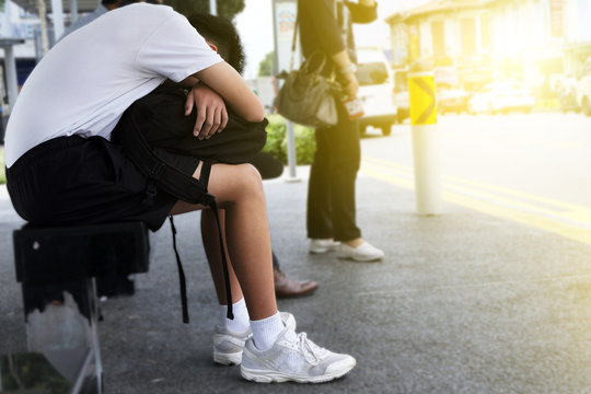 Boy Sleeping On The Terminal Bus Stop