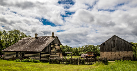 Fototapeta na wymiar Old Settler's Farm House and Barn with field