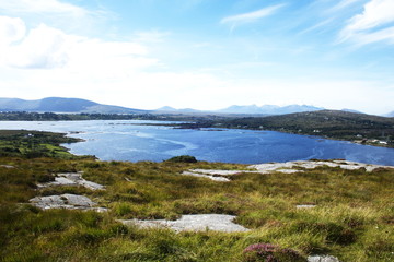 A landscape with a view of sea and mountains. 