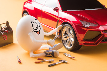 Funny egg car mechanic repair the wheel - 193840963