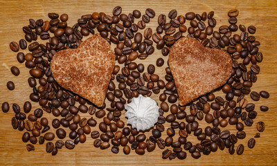 coffee beans and biscuits on a wooden table