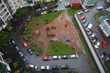 Parked cars in the courtyard of a block of flats in a new district of St. Petersburg. view from above