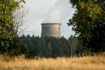 coal fired power station with cooling tower releasing steam into atmosphere