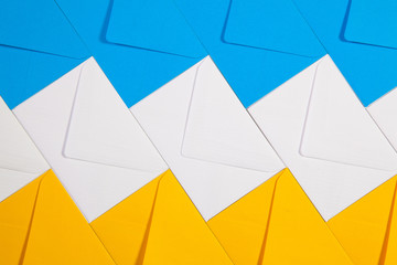 White, blue and yellow envelopes on the table