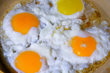eggs are fried in a frying pan