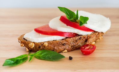 Mozzarella cheese with tomato, basil and cereal bread