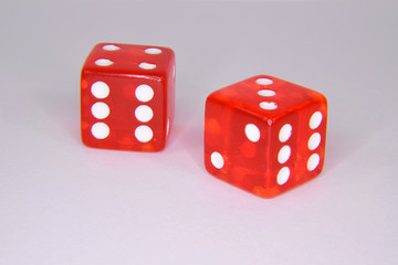 Thrown Red Casino Gambling Dice - Showing Numbers Three and Four