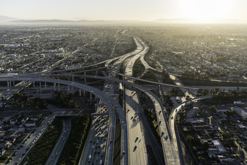Aerial sunrise view of 105 and 110 freeway interchange ramps in Los Angeles California.