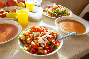 Healthy breakfast with fresh salad, porridge and orange juice
