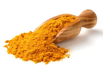 Turmeric powder in the wooden scoop, isolated on white - obrazy, fototapety, plakaty