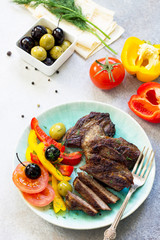 Appetizing barbecue steak from beef sirloin full roast served with fresh vegetable salad.