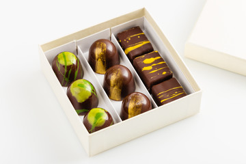 Set of luxury handmade bonbons in gift box on white background