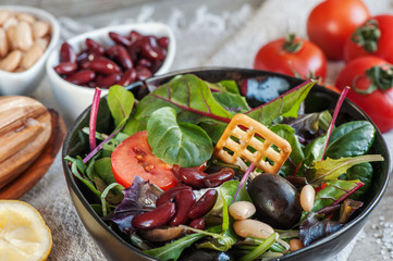 Salad diet for weight correction from the leaves of Lollo Rosso lettuce, watercress salad and other green herbs with tomatoes, olives and fitaki.