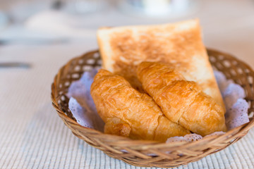 Fresh baked croissants on basket, Breakfast concept on table. Food concept, Breakfast in hotel