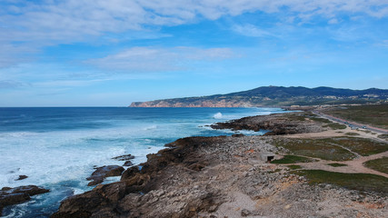 Fototapeta na wymiar Aerial view from the Portuguese coastline with the ocean and a mountain in background. Cascais Portugal