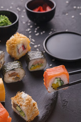 Set of sushi maki and rolls on gray background