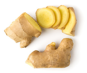 Ginger root cut into pieces on a white