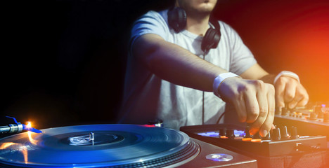 DJ plays set in vinyl player