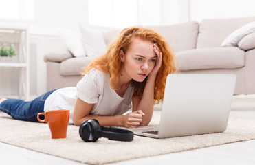 Confused student girl using laptop