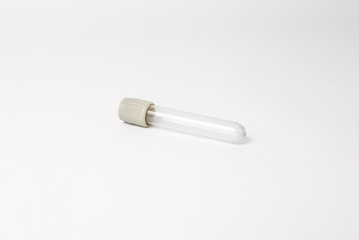 isolated grey blood testing tube lying on the white background
