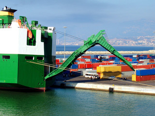 Cargo ship unloading. Freight ship unloading in port.
