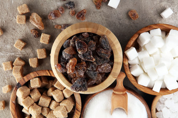Various types of sugar, brown sugar and white on table
