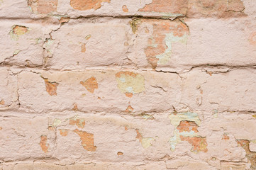 Close-up Textured background of multi-layer flaking paint on the wall. Mixing different colors of paints in the cleaved layers on the surface. Grunge texture with a deep pattern