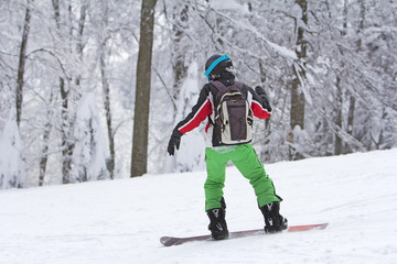 Fototapeta na wymiar Winter sport snowboarder at ski slopeand alps mountains landscape