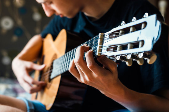 musician playing acoustic guitar, live music background