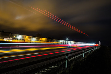 Fototapeta na wymiar light trails after a truck driving on a bridge